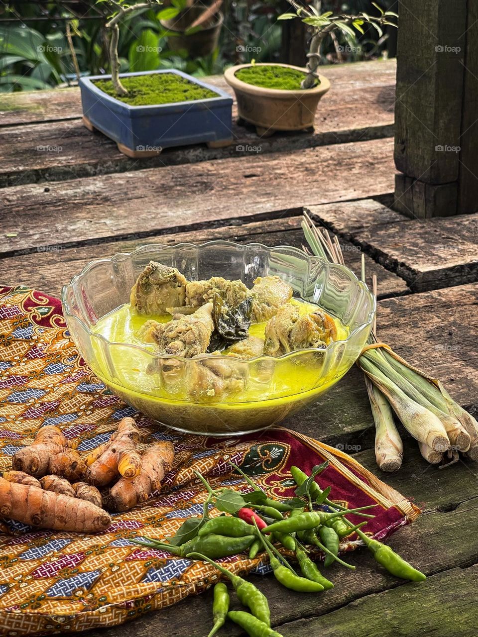 Malay traditional dish, chicken cooked in coconut milk, turmeric and hot green chillies. Eating outdoor