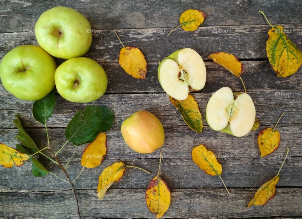 Autumn wallpaper with apples on wooden table.