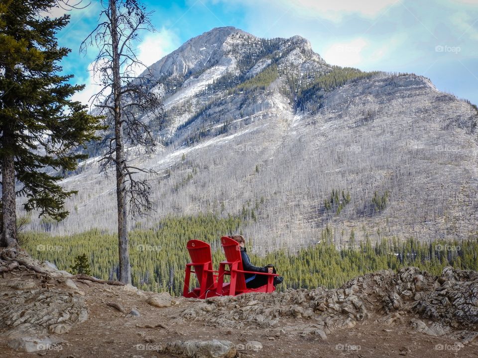 Albertas lake Minnewanka and some muskoka chairs 