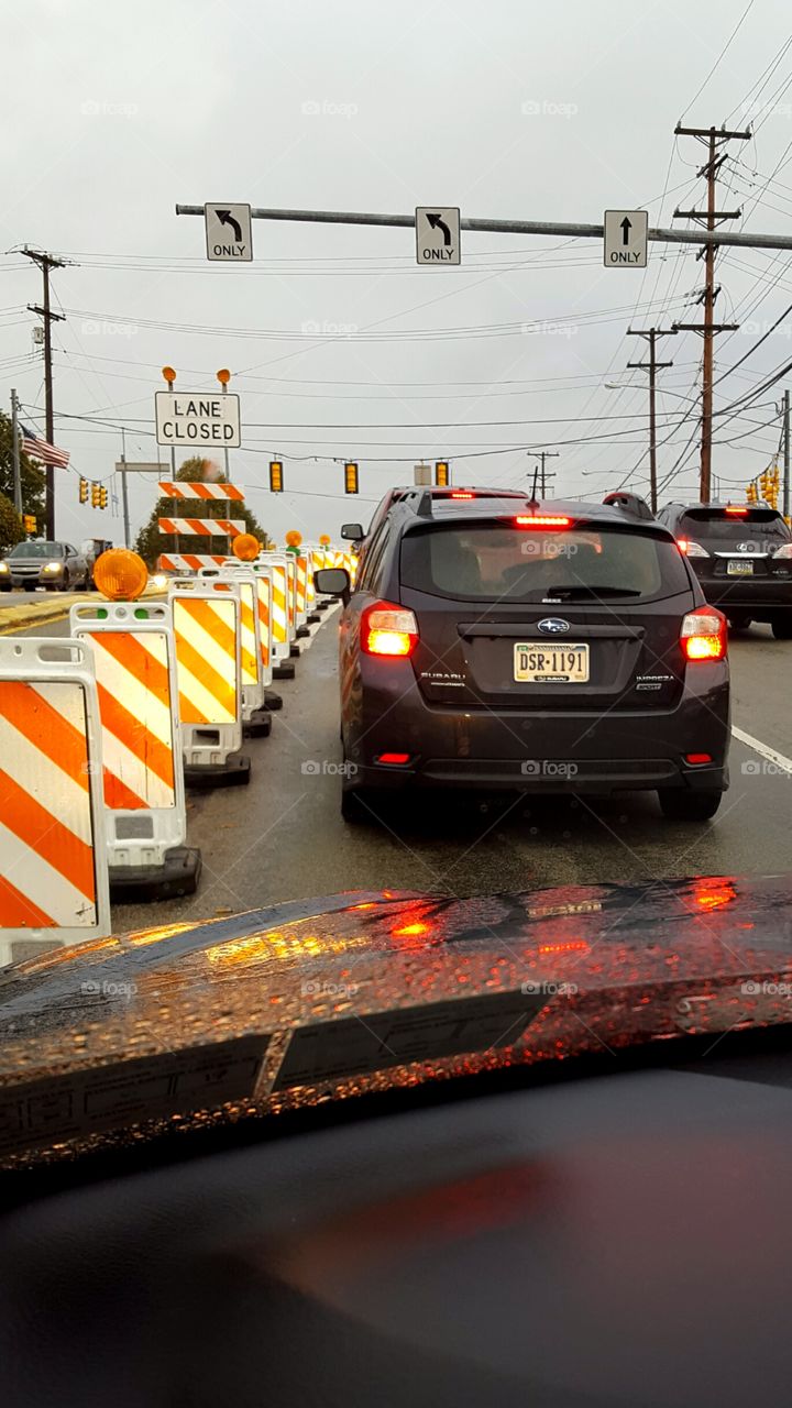 Construction pylons line the road during my commute through the city.