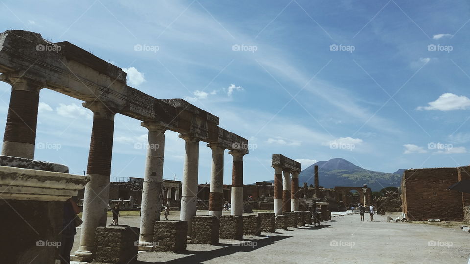 Destruction Looming. This is a photo from Pompeii with Mt. Vesuvius creeping in the background to give an interesting perspective.