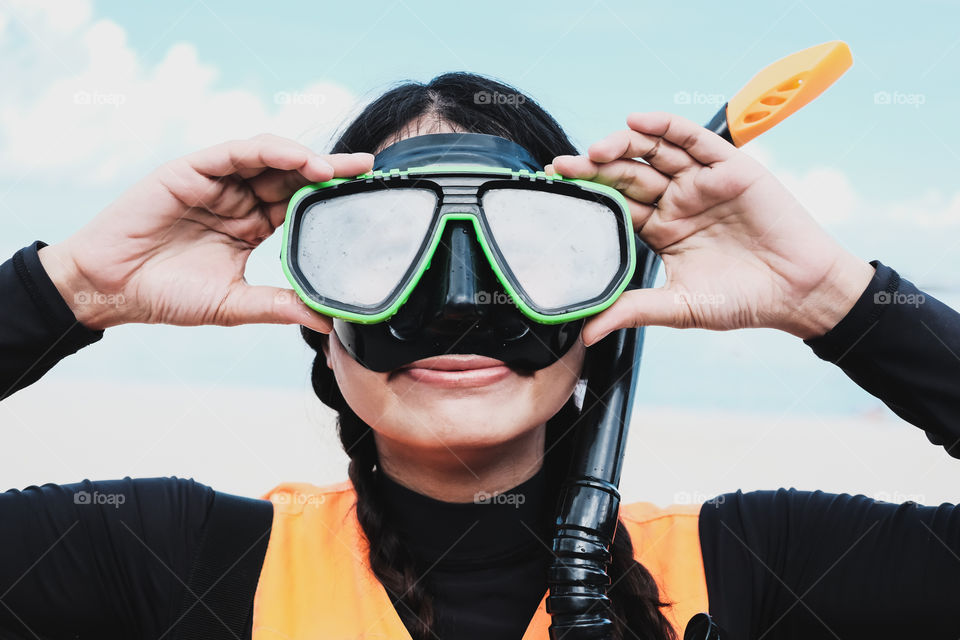 Close-up Asian woman wearing a black half- face snorkels