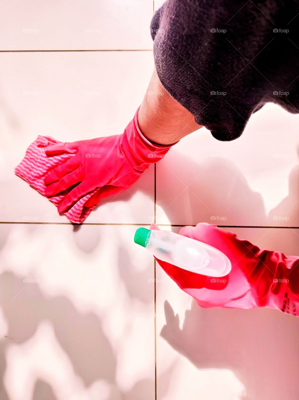 Floor cleaning with spray bottle and red rubber gloves
