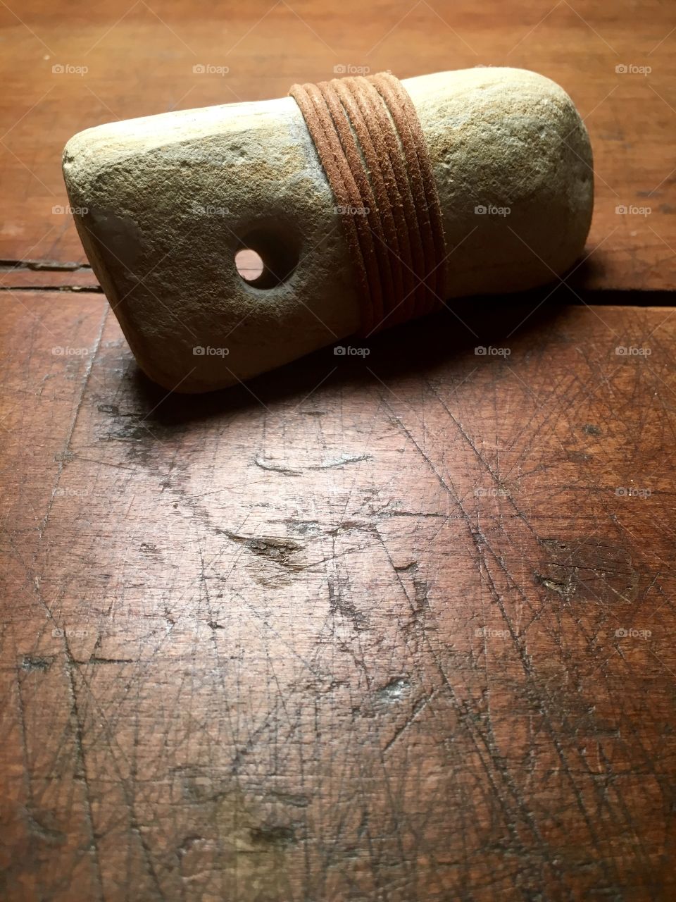 Leather bound stone with natural hole 