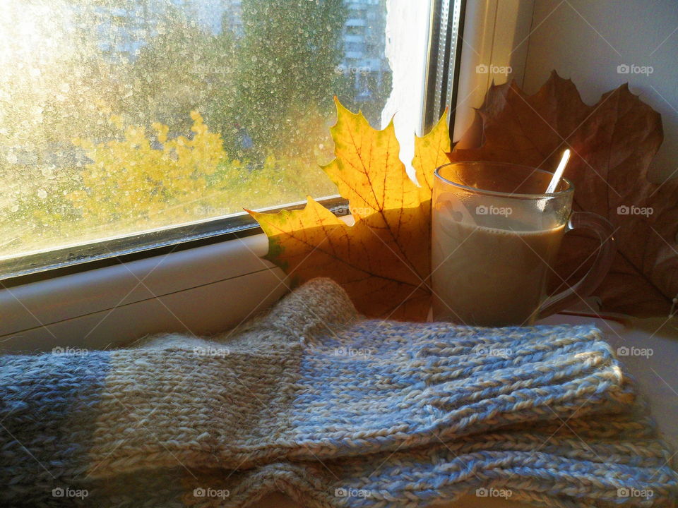 a cup of hot chocolate and warm socks on the windowsill