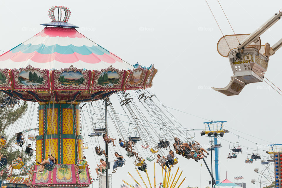 Riders going to round on a carousel at the state fair