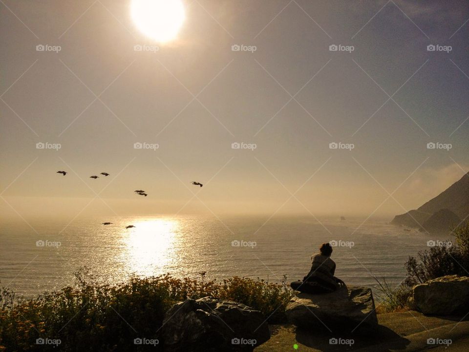 Person sitting on rock