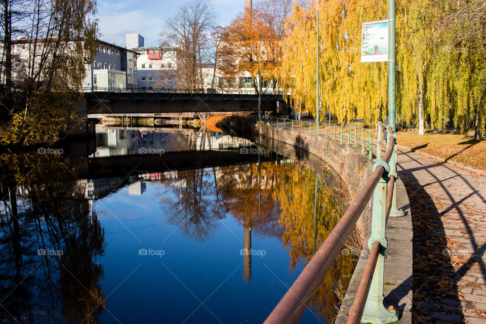 urban reflections onto the still River in central Borås Sweden