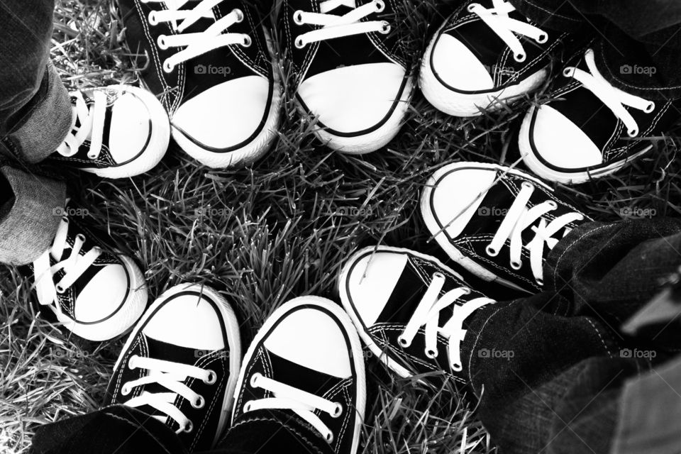 Family in a circle, only shoes visible 