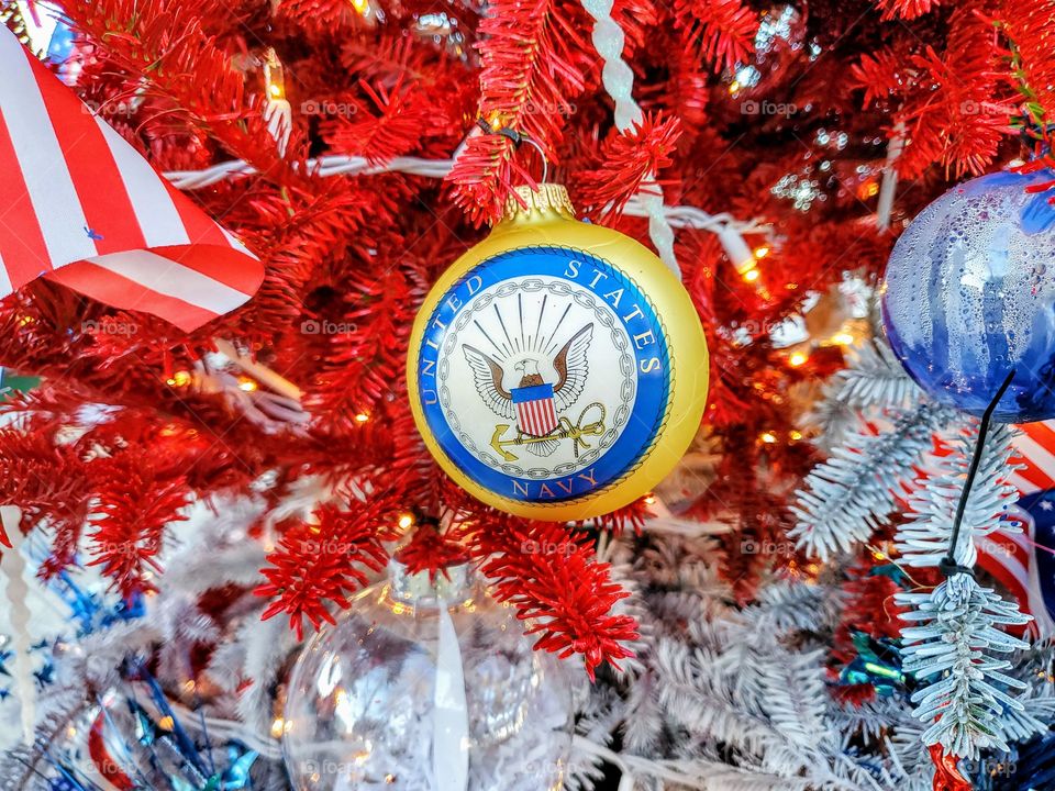 United States Navy Christmas ornament hanging on a red, white and blue Christmas tree honoring all branches of service