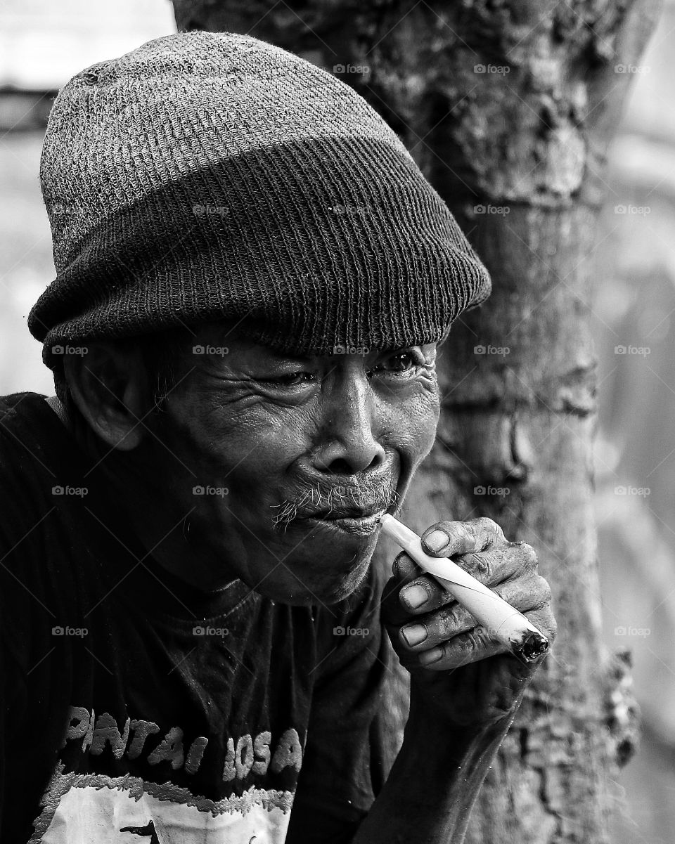 Close-up of a senior man smoking cigar