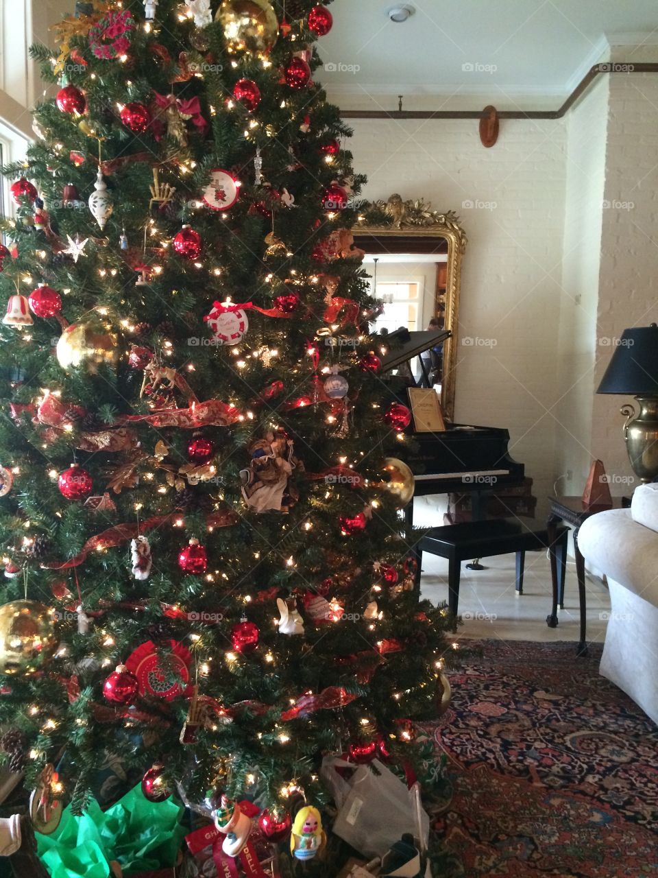 Christmas Day, cozy home, colorful Christmas tree covered in lights, and a grand piano waiting to play Christmas carols