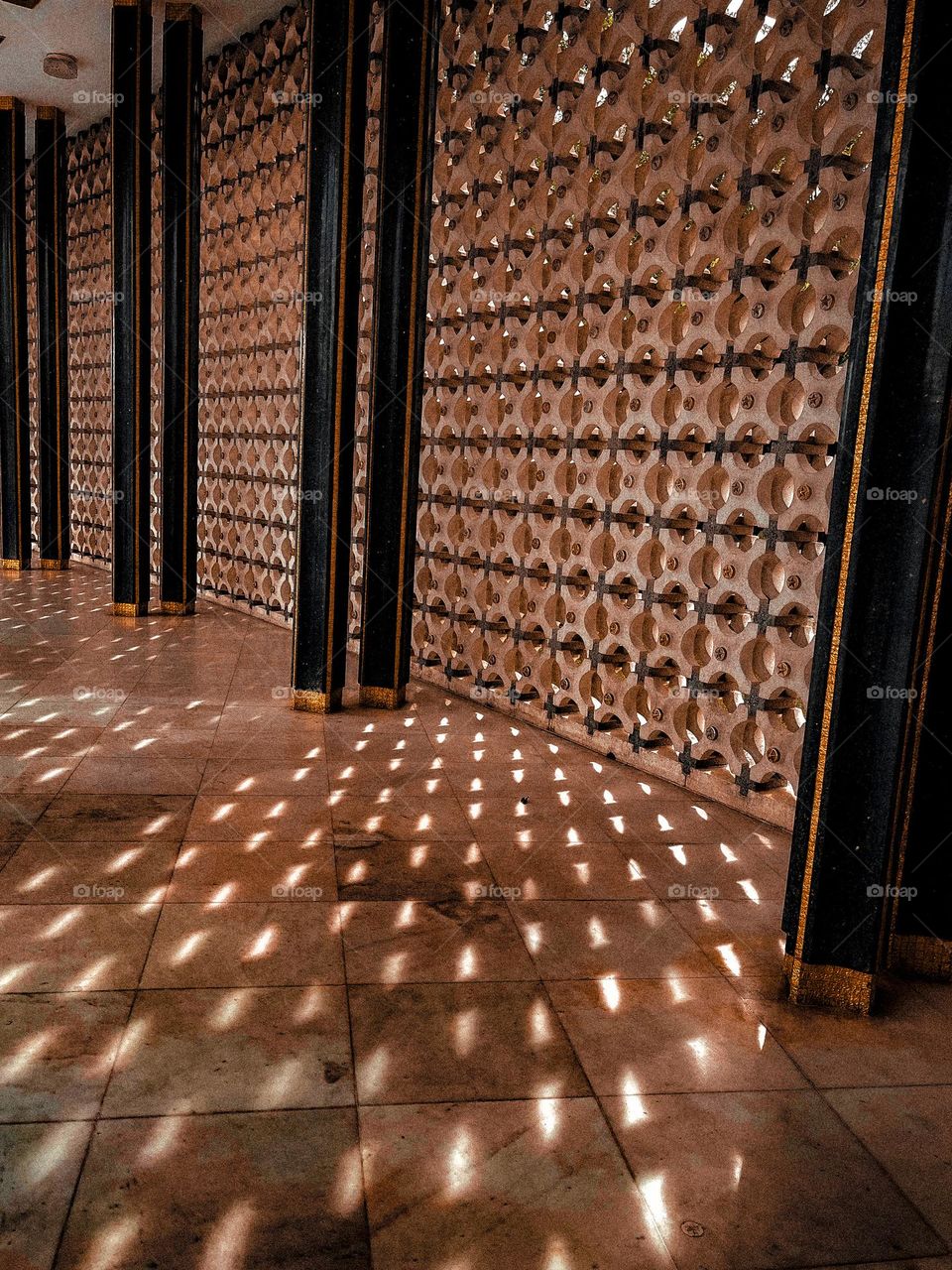 Sun rays pierching through the holes and make a beautiful shadow patterns