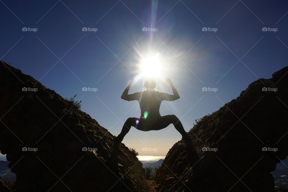 Sun#rocks#humans#position#girl#sky