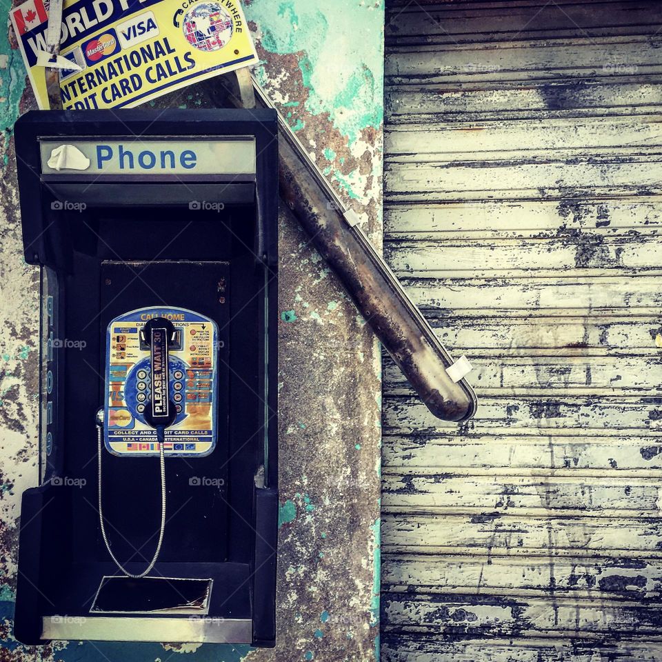 Phone home, pay phone still in operation, working pay phone in St. Martin, old and abandoned things, things on an island 