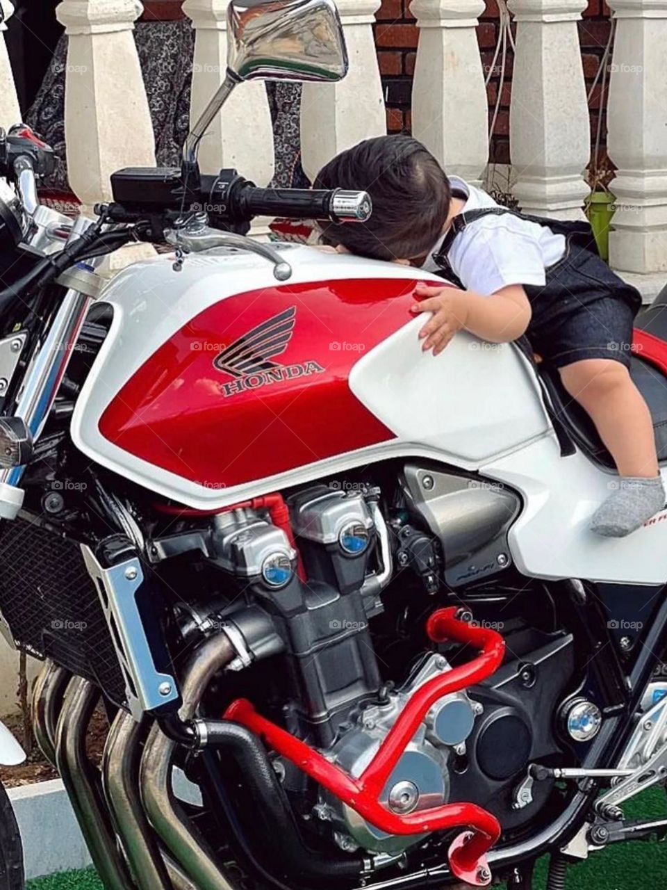 He is in love with this motorcycle as his father is... Like father like son