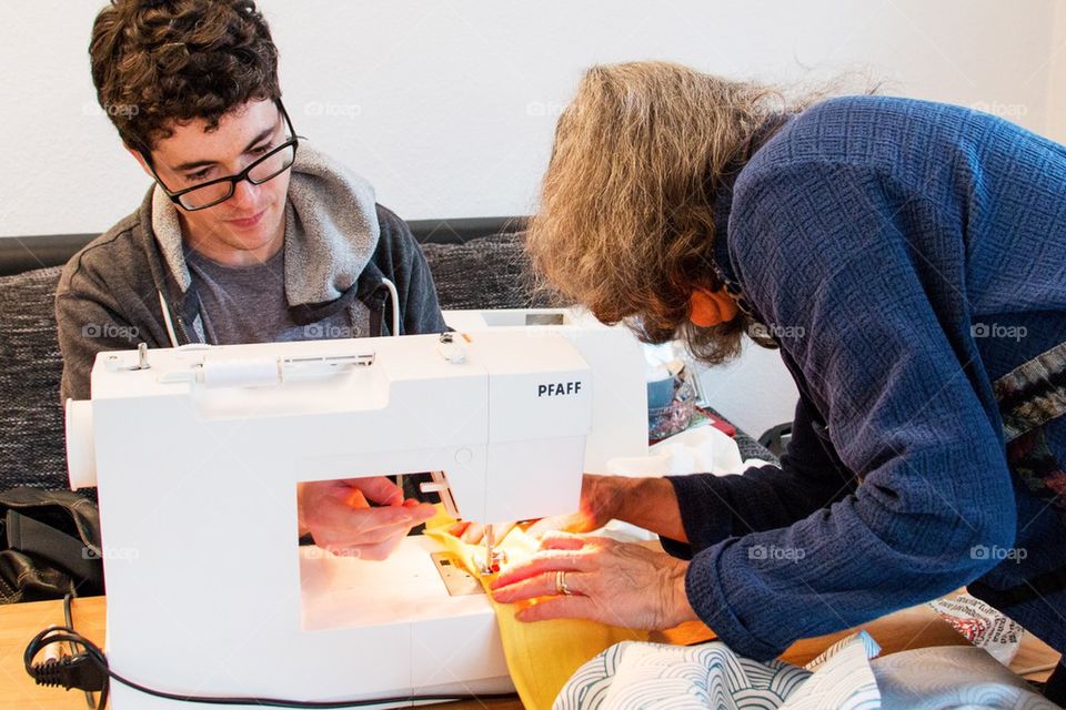 Man learning to sew