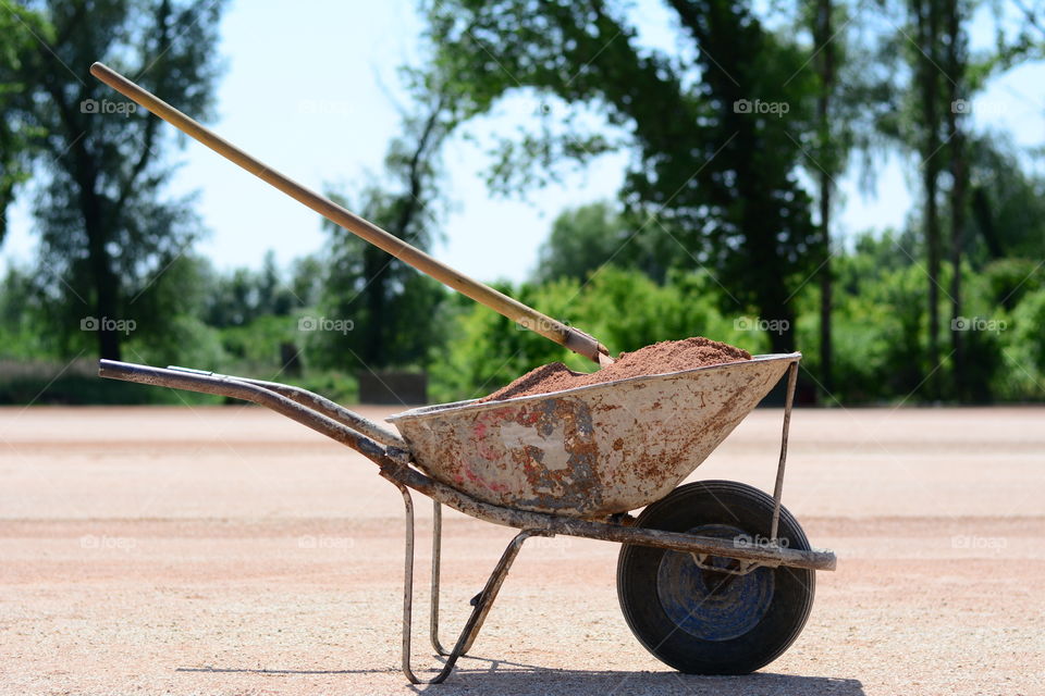 Shovel in sand stabbed in a trolley