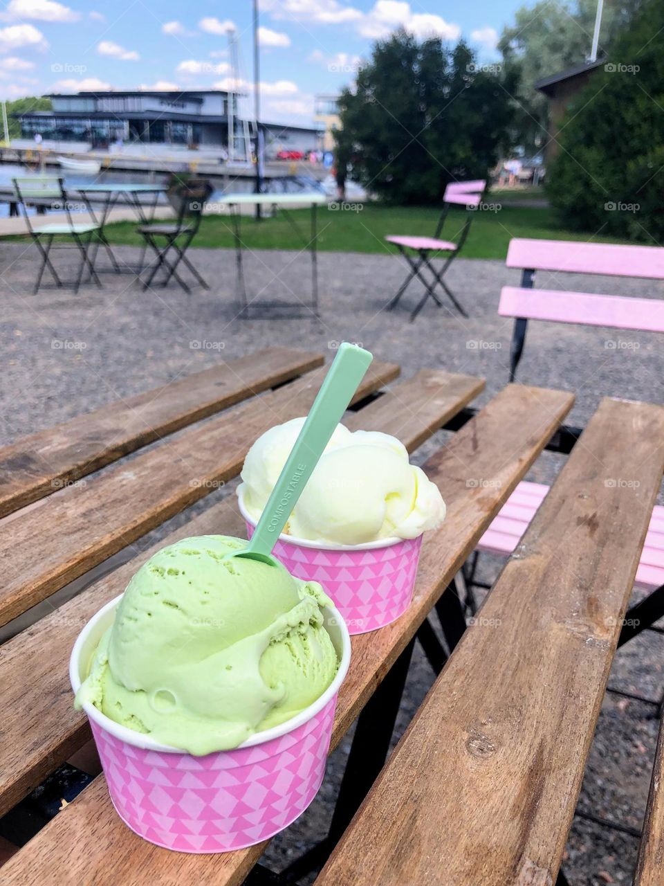 Summer dream: delicious ice cream on the public park wooden table 