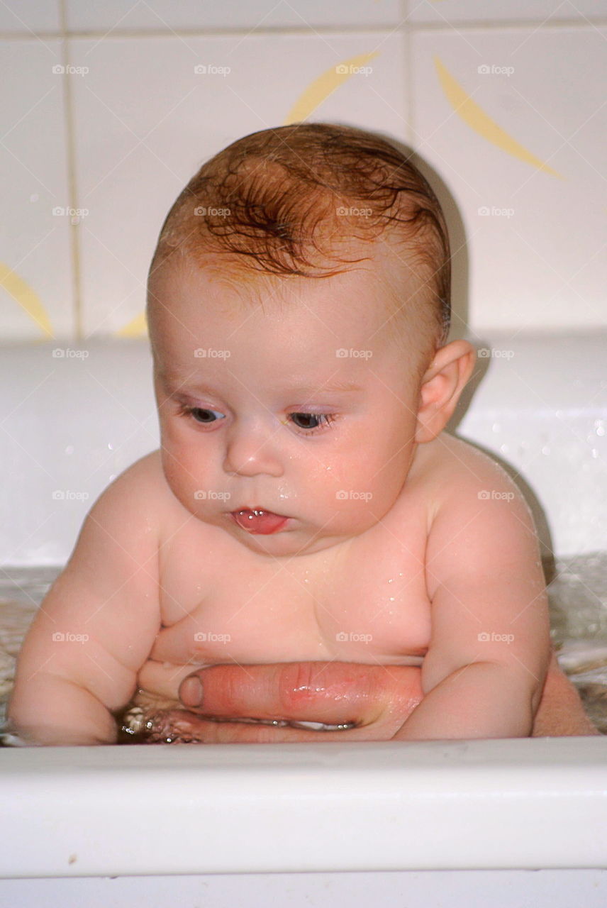 Baby bathing in the bathtub