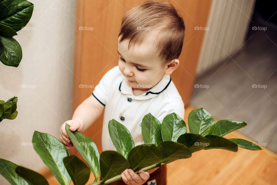 baby cares for flowers