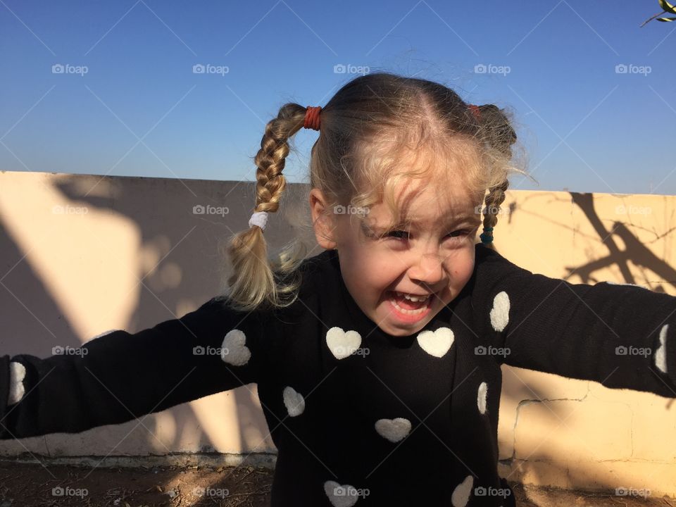 Happy girl standing near wall