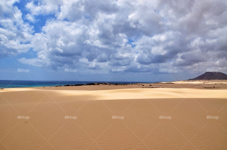 dramatic sky over the sandy dunes of corralejo on fuerteventura canary island in spain