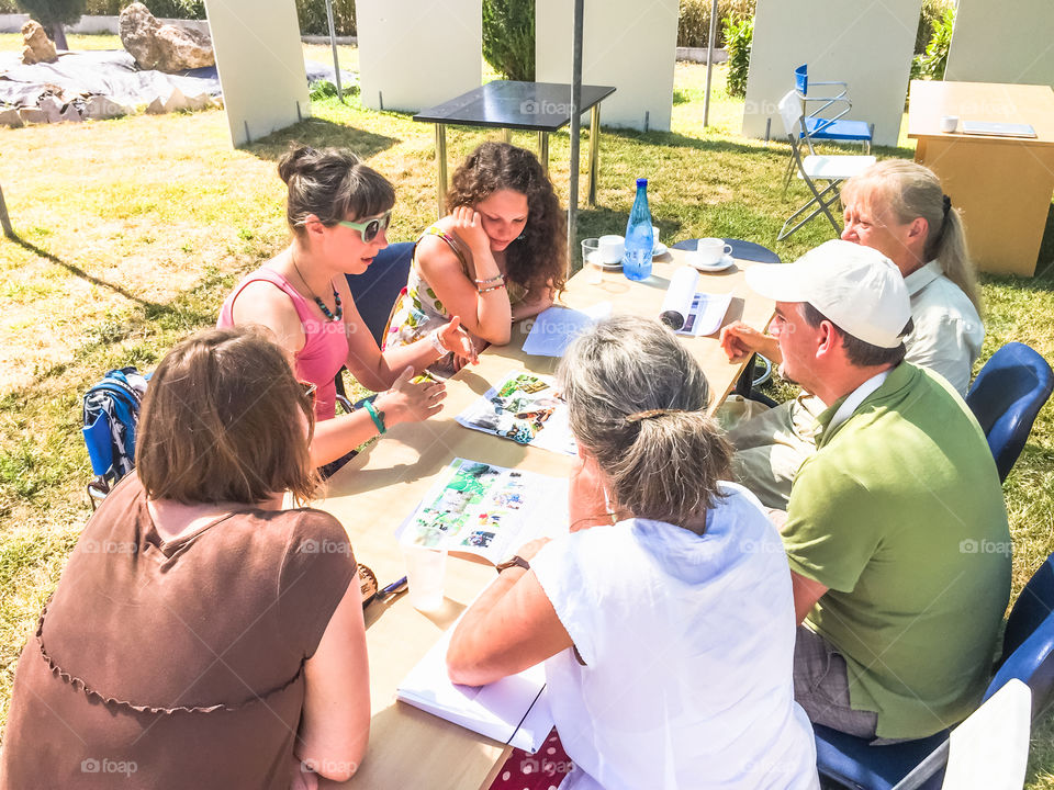 Businessmen And Businesswomen At The Desk Planning Strategy At Outdoor Business Meeting
