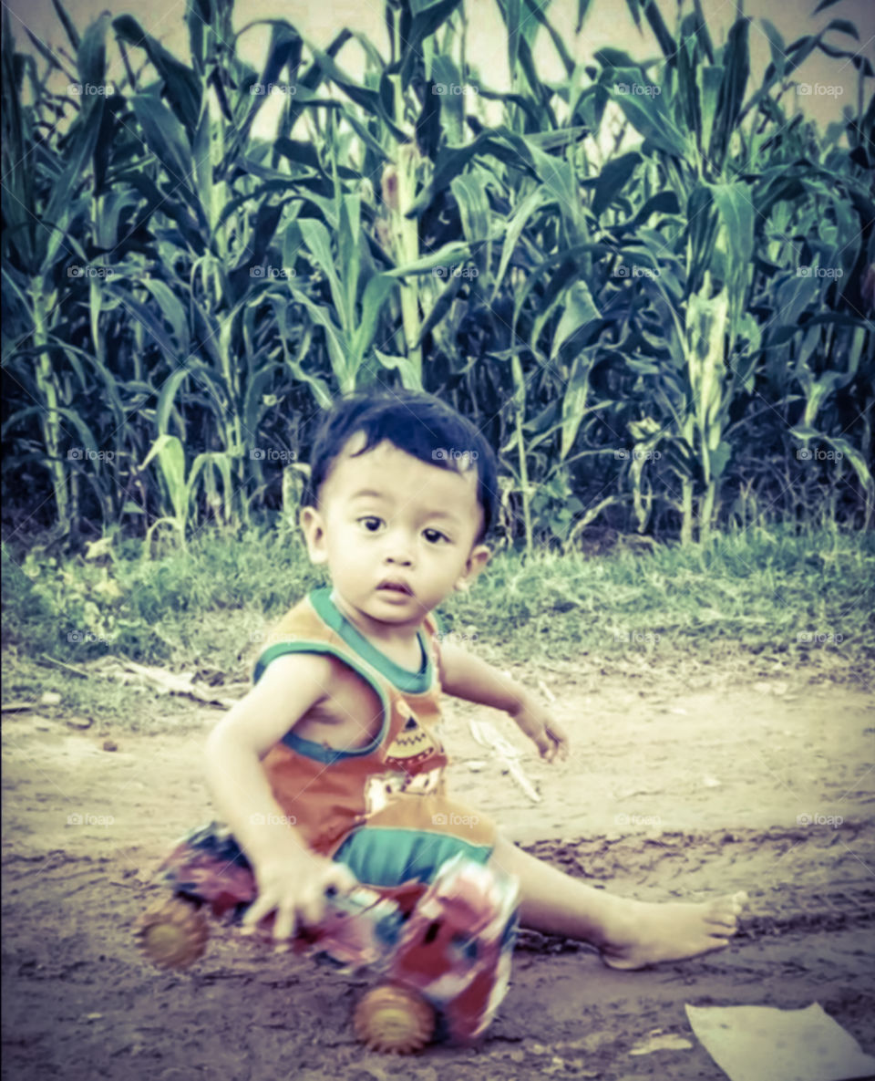 cool boy playing in the cornfield