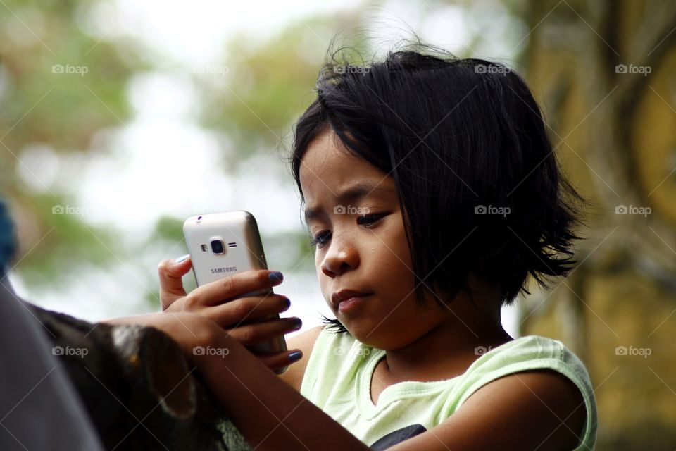 young girl watching a video on a smartphone