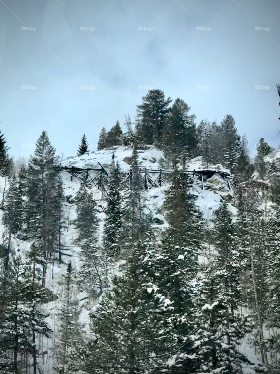 Old mining timbers in the Colorado mountains covered in snow.