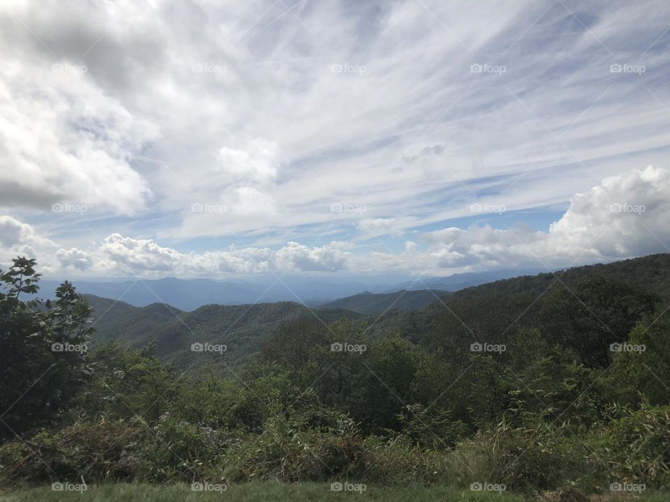 Beautiful Clouds over lush, Green mountains