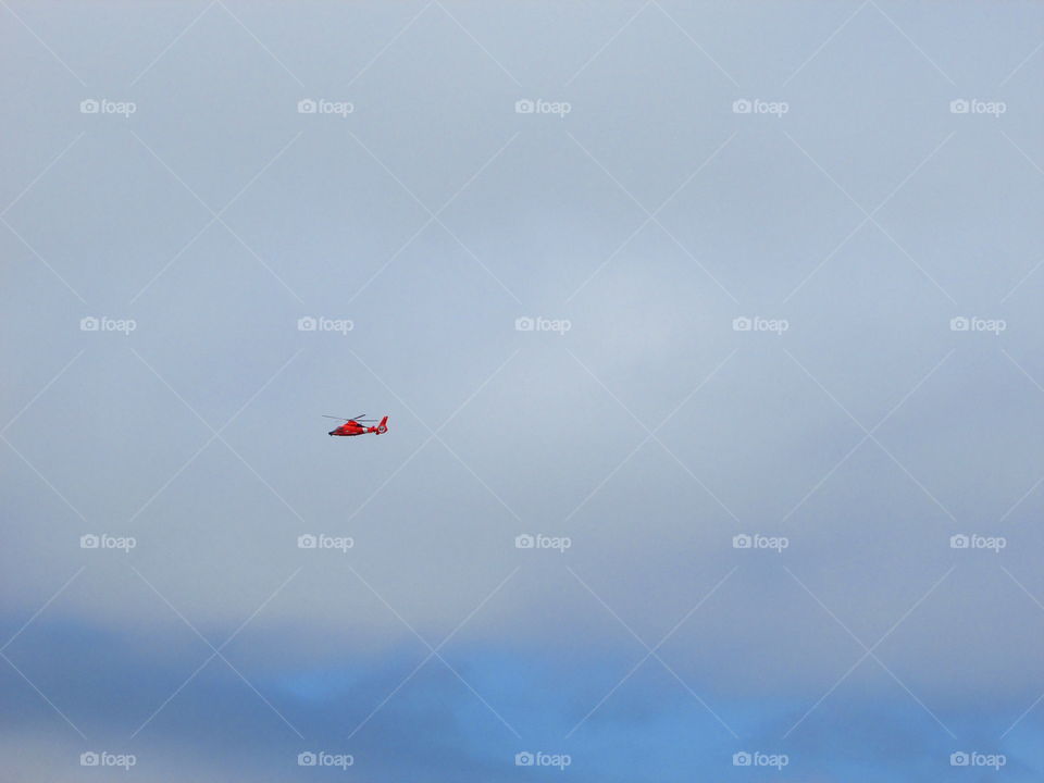 red helicopter in the sky