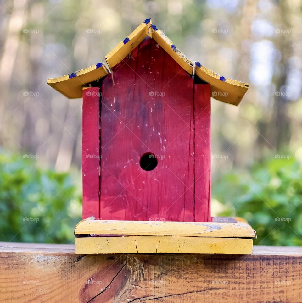 A purple and yellow birdhouse.