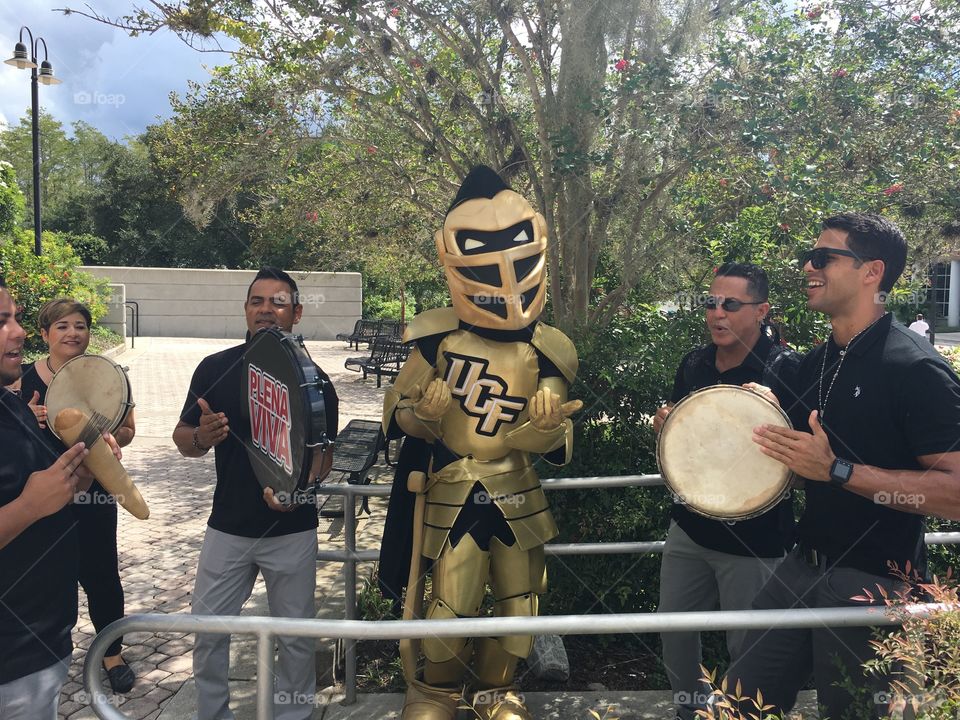 University of Central Florida mascot Knightro.  Latin music Latin dancing.