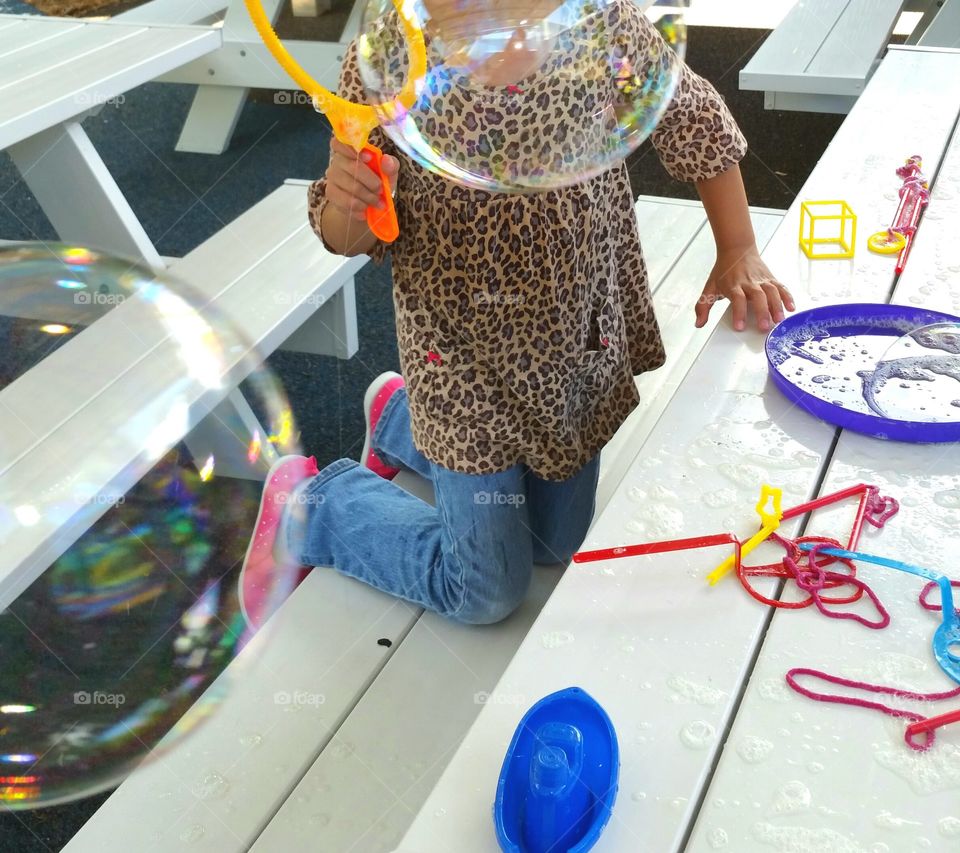 Girl making bubbles