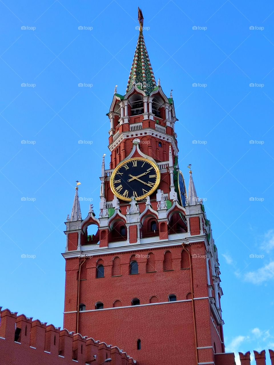 Moscow.  The Red Square.  Bottom view.  Spasskaya tower with chimes and a five-pointed red star.  Red Kremlin walls