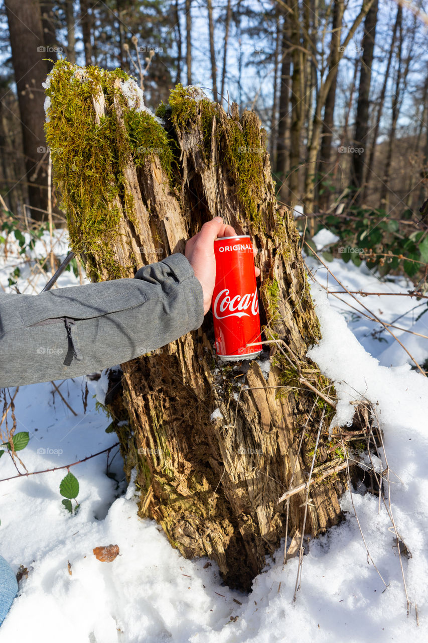 hand holds Coke can