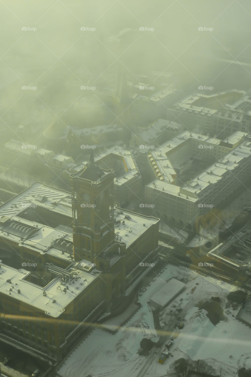 Aerial view of Berlin city showing its buildings covered with fog.