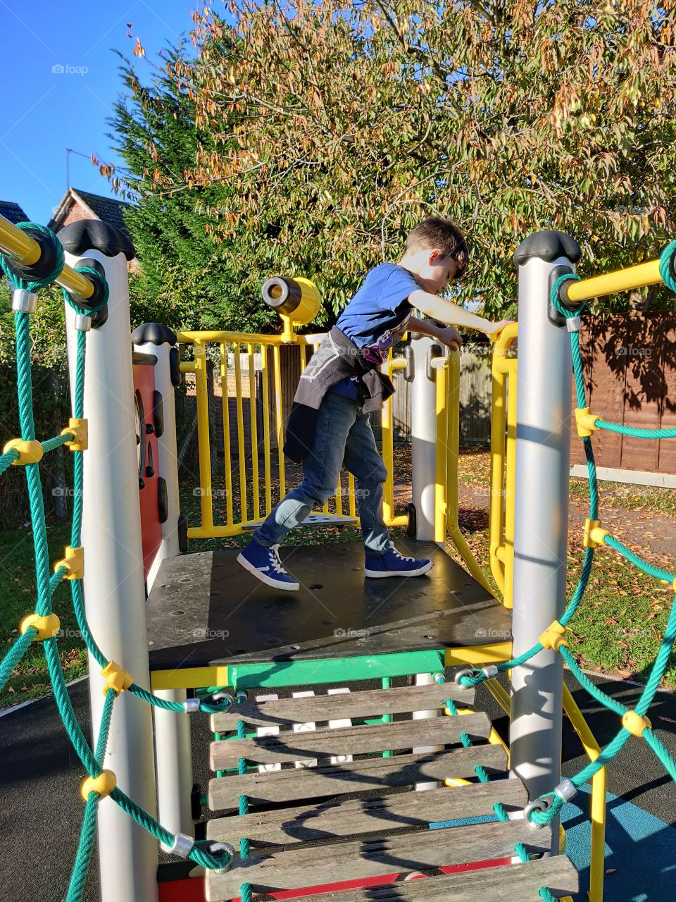 Boy playing on playground equipment