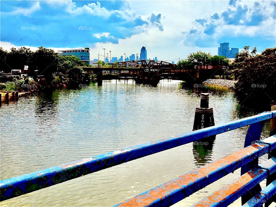 The East River at Newtown Creek in Long Island City, Queens, NY seen from atop the Pulaski Bridge on a sunny afternoon in the springtime of 2029. Hypnotic Productions