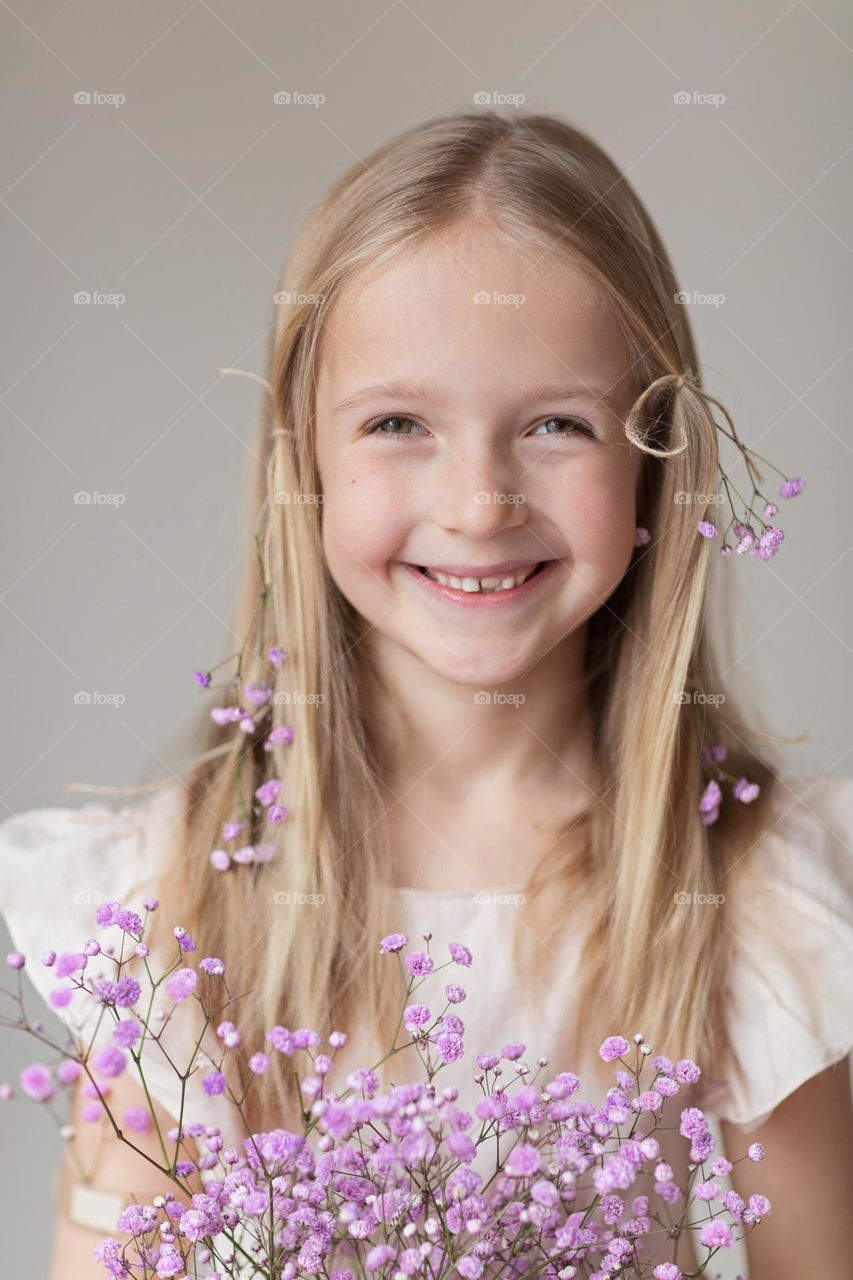 Candid portrait of happy girl with blonde hair 