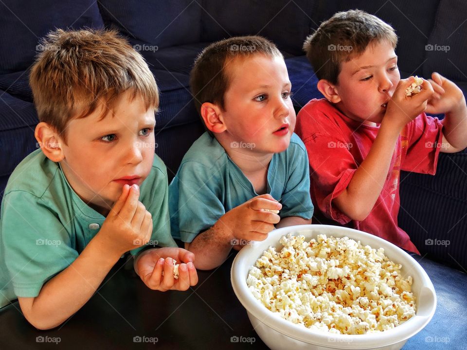 Kids Eating Popcorn While Watching TV