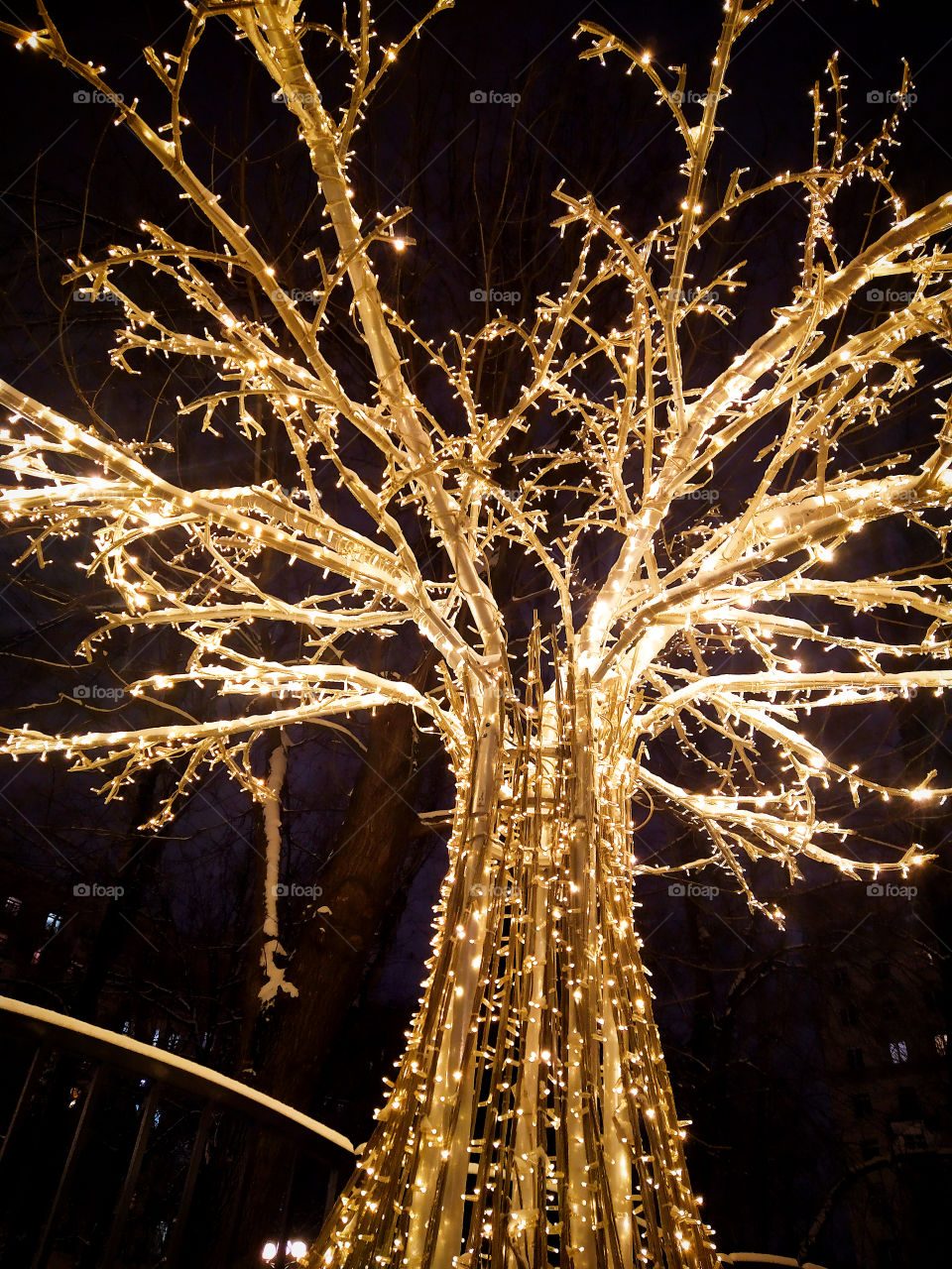 Tree in a luminous garland on a Moscow street