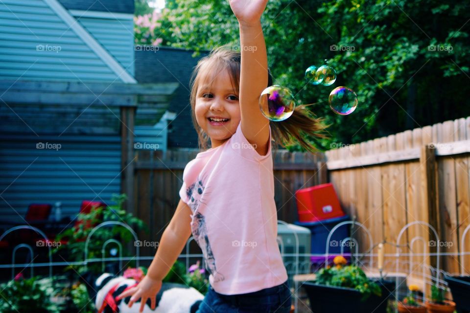 Girl playing with soap bubble
