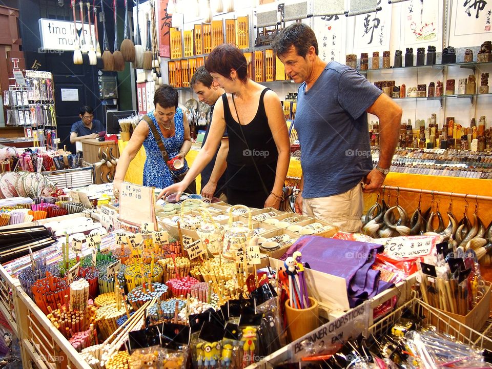 tourists looking at souvenirs sold at chinatown in singapore