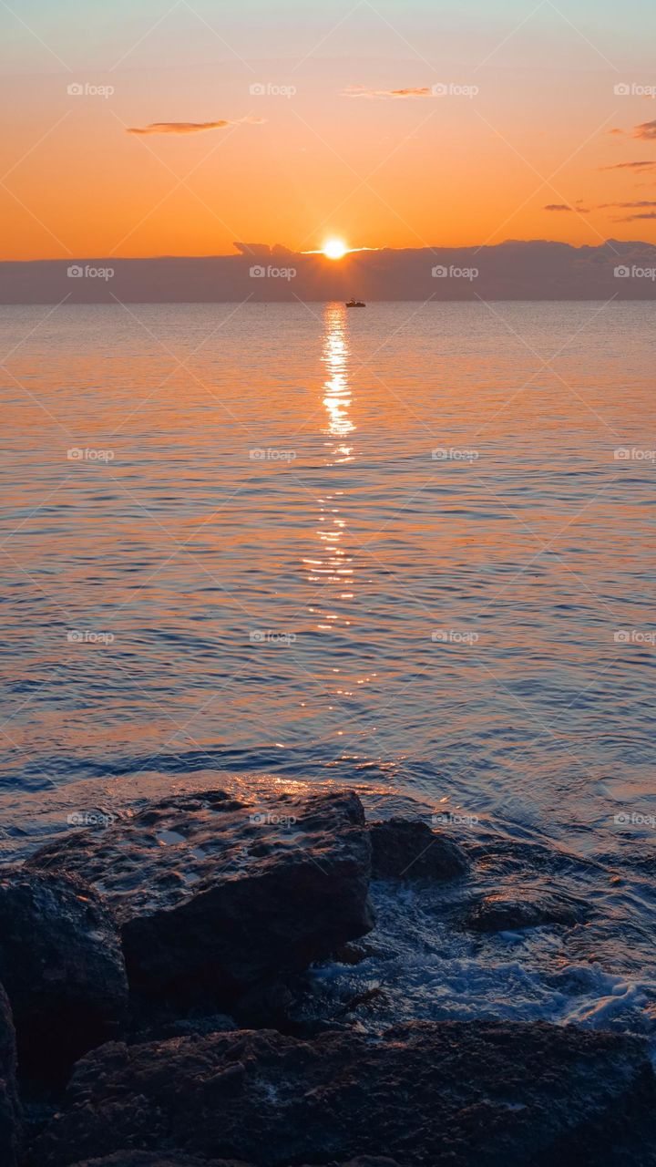 Sunset, sea.,boat,rocks