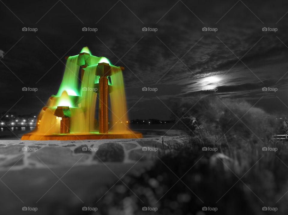 Color lights fountain. Fountain used by town to oxygenate water from the potable water plant.  Shot at big moon night.