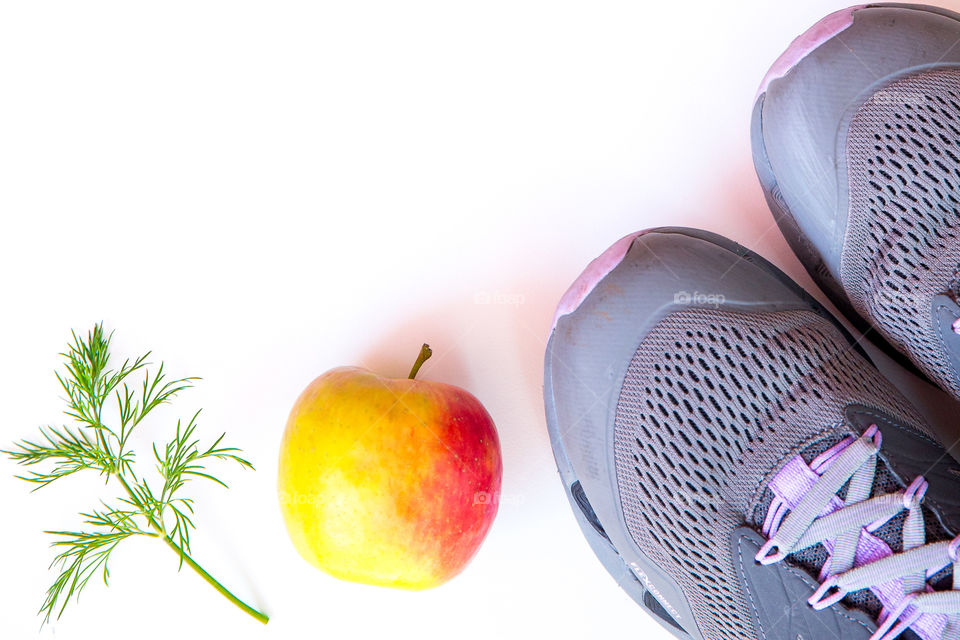 Staying in shape being healthy and vibrant is about good nutritious food and exercise. Simple minimalist image on white background. Staying in shape is about balance.