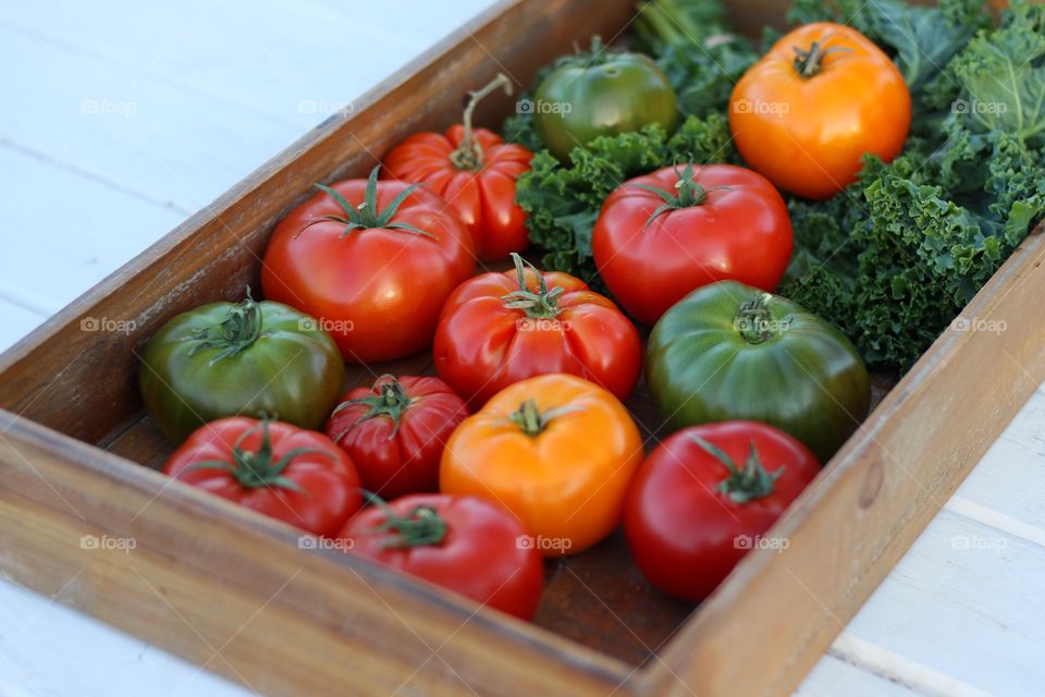 Tomatoes in basket on table